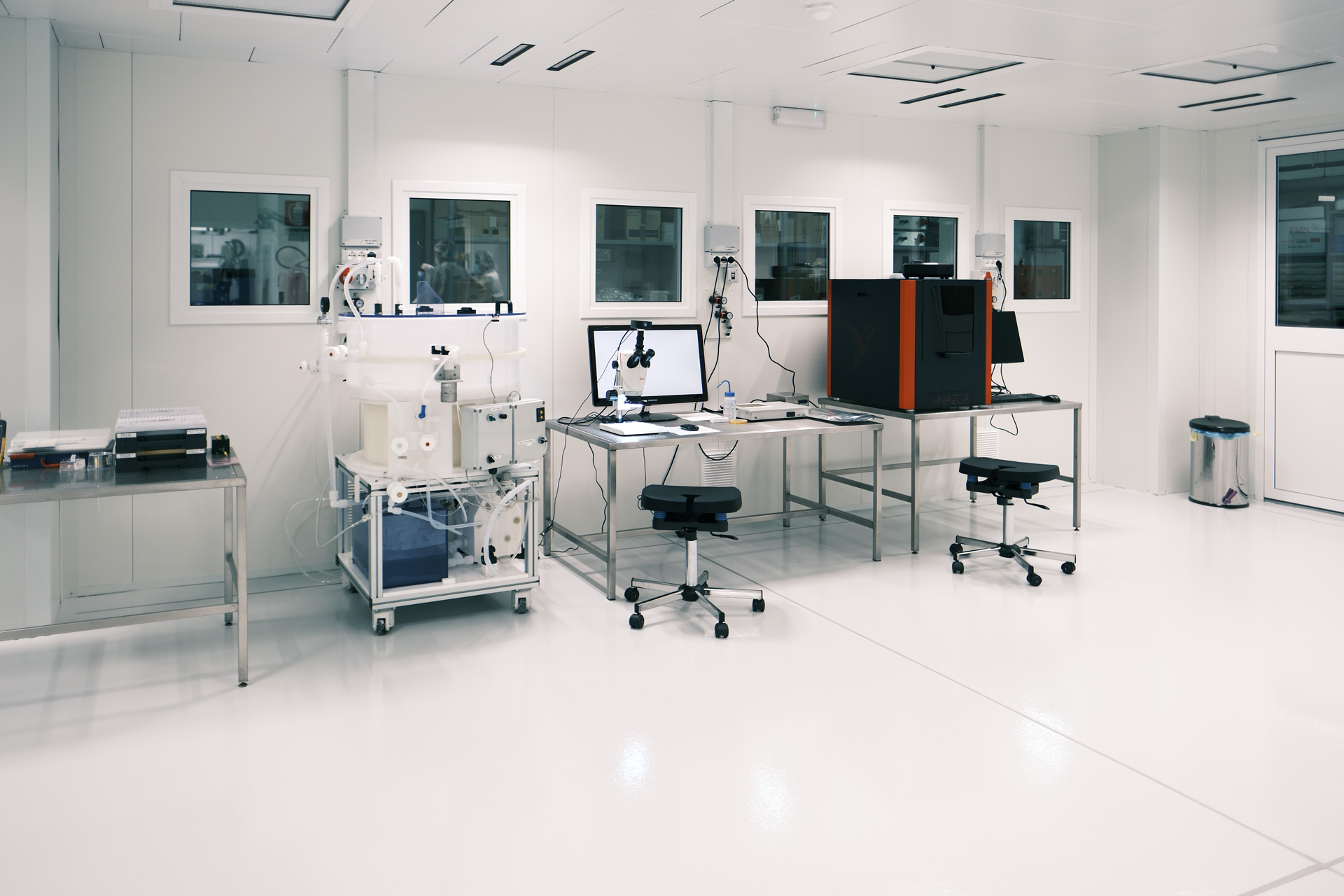 Process equipment and workstations installed inside an ISO 6 clean room for photonics and semiconductor development activities.