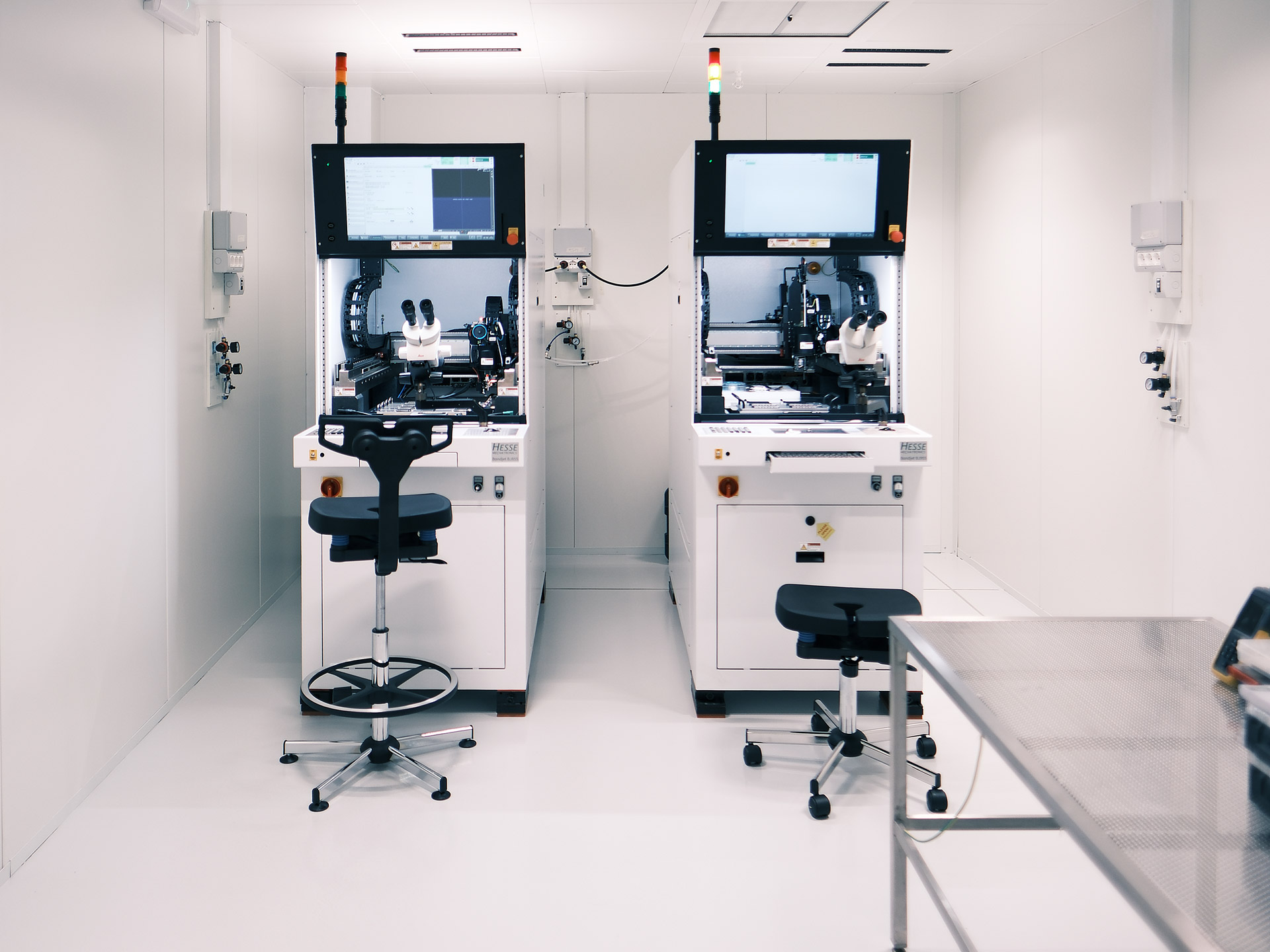 Wire bonding equipment installed inside an ISO 6 clean room for microelectronics and semiconductor assembly processes.