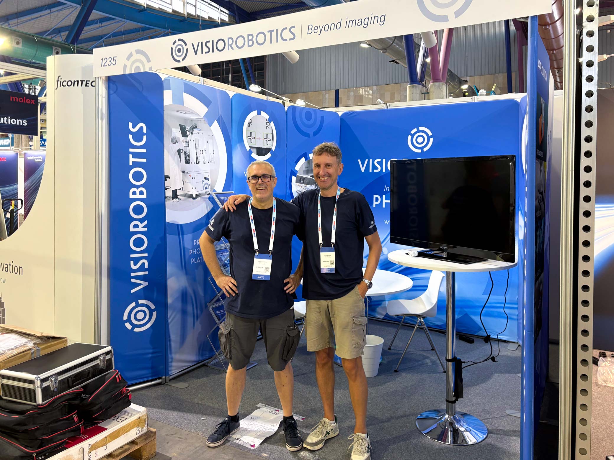 Two Visiorobotics representatives at booth #1235 during ECOC 2026 in Málaga.